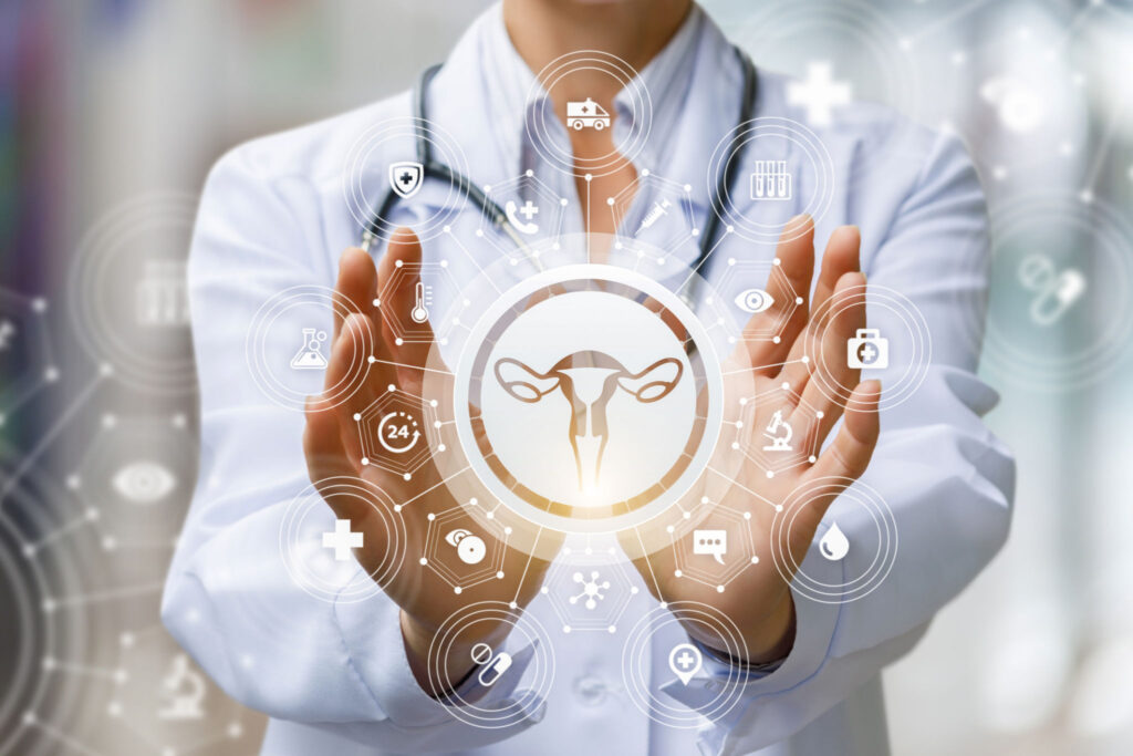 The doctor shows the icon of the female uterus on blurred background.
