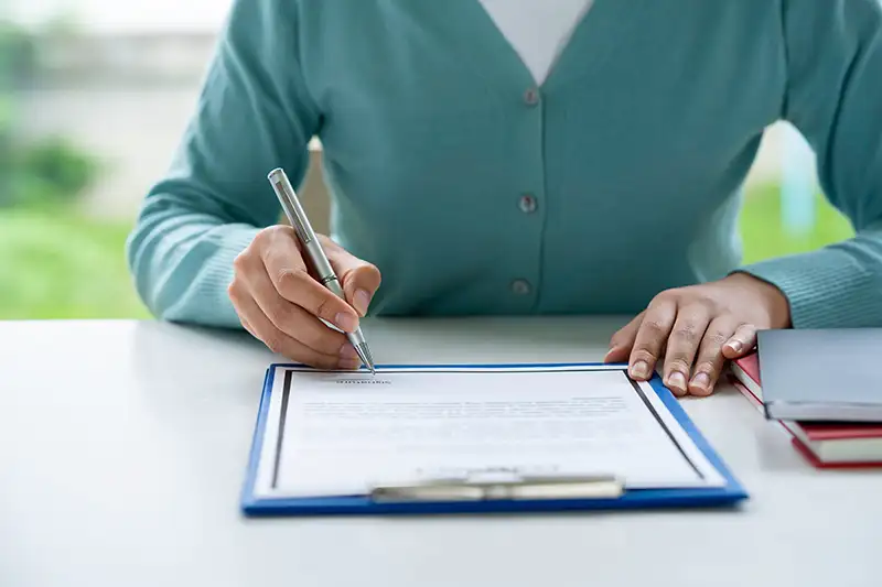 Woman filling out surrogacy paperwork in California